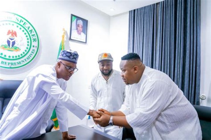 
Netizens react as Cubana Chief Priest ‘breast feed’ son 